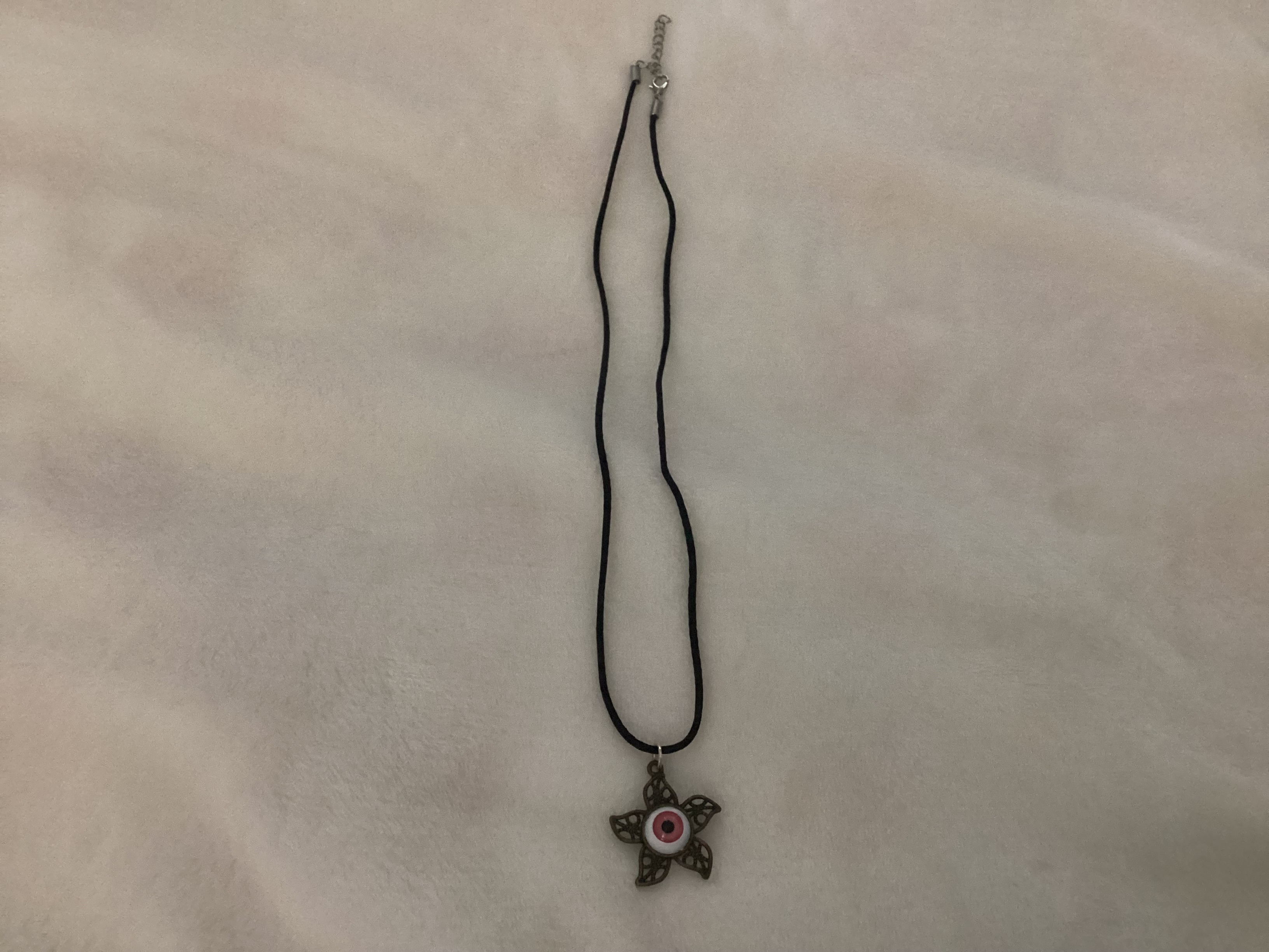 pink star eye pendant