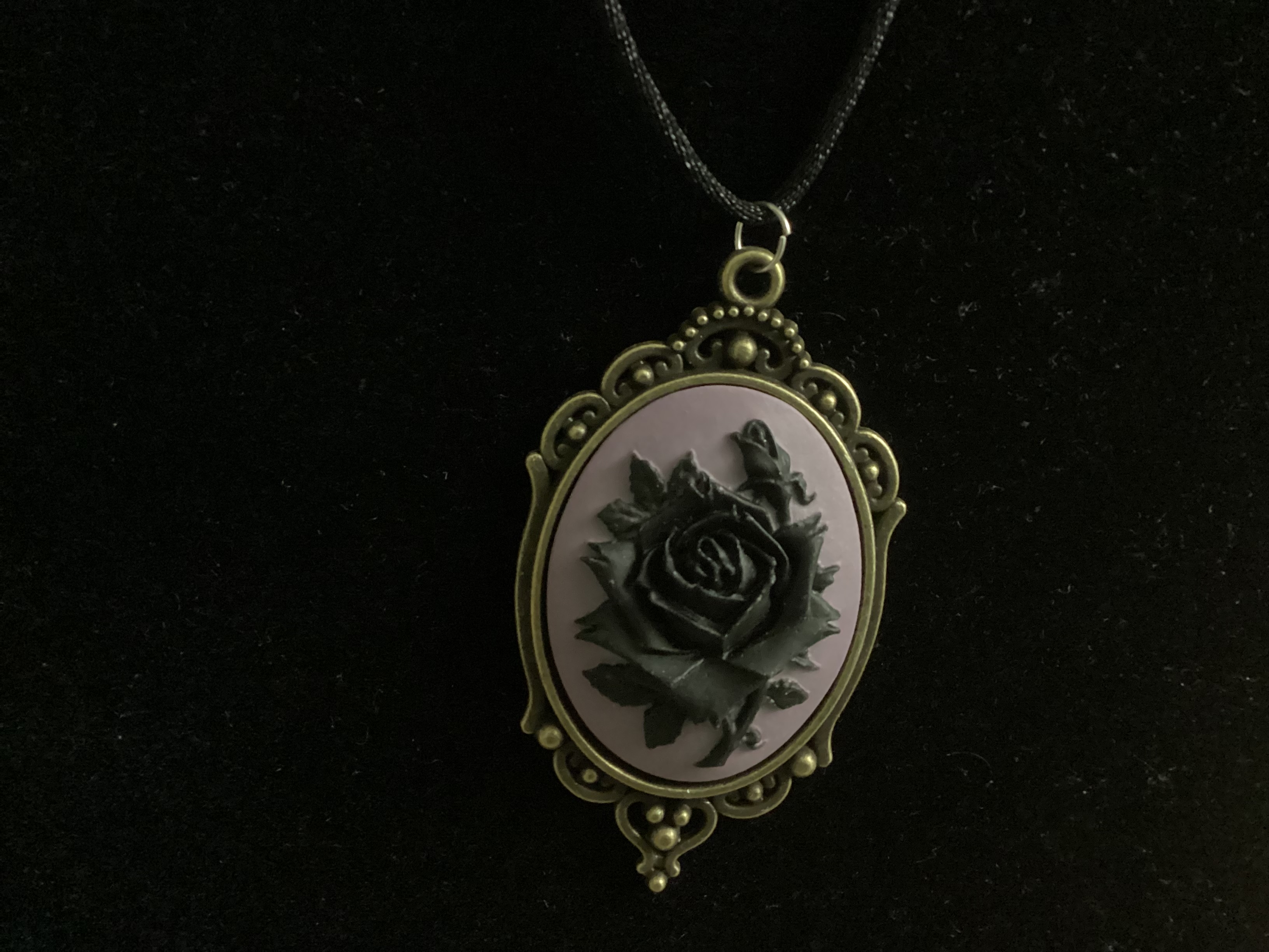 black rose on purple background pendant